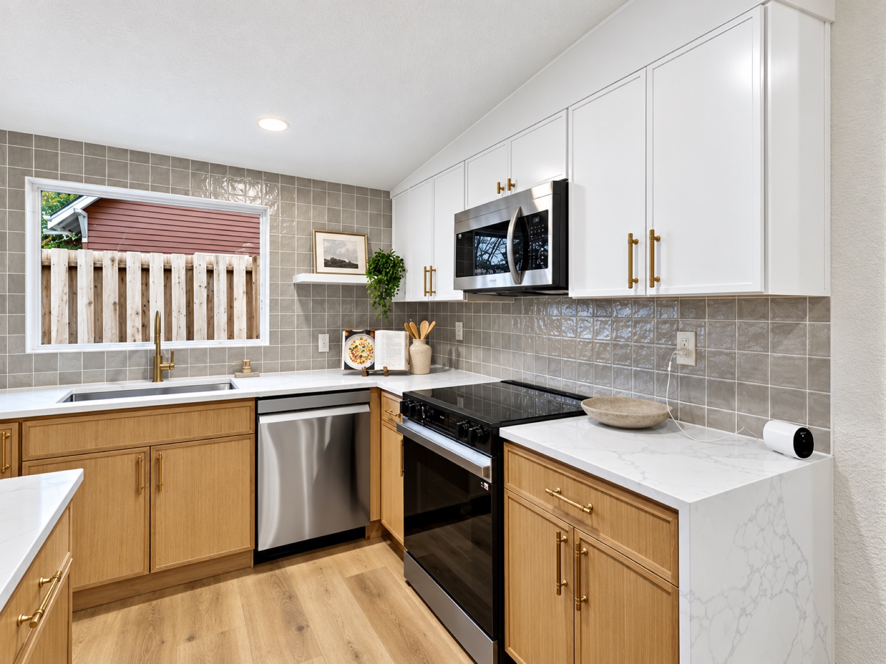 White kitchen with marble counters and a range
